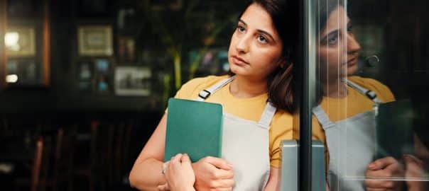 Waitress thinking, sad or woman at coffee shop with tablet for inflation, bankruptcy or startup fail. Stress, reflection and barista at cafe with small business challenge, financial crisis or pensive