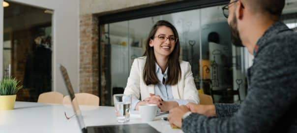 Woman hospitality manager interviewing entry-level male candidate for job opening.