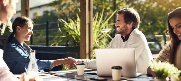 Business people, meeting and handshake at cafe for introduction, onboarding and remote work opportunity. B2b worker or clients shaking hands at coffee shop of group project deal, interview or success.