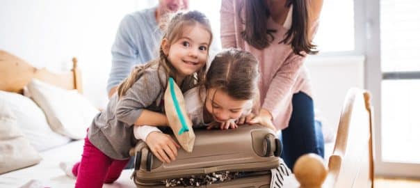 Young family with two children packing for holiday.