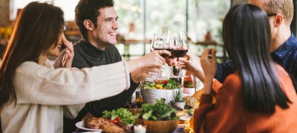 Dinner with friends. Group of young people enjoying dinner together. Dining Wine Cheers Party Thanksgiving Concept.