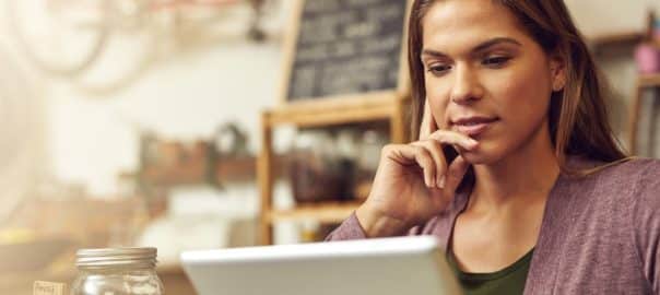 Business owner, thinking and woman in store, tablet and internet with connection, online reading and decision. Person, entrepreneur or employee with tech, digital app for invoice and solution in cafe.