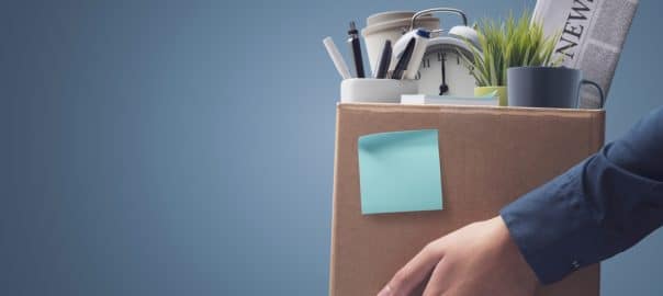 Office worker carrying personal belongings in a box after being fired, unemployment, or relocation and career concept