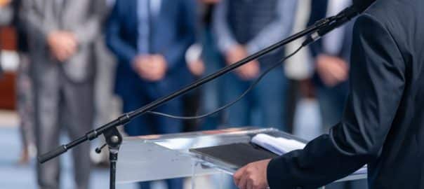 Political campaign before elections with a political candidate addressing an audience with a powerful speech.
