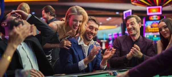 Intense Win in a Poker Game on a Casino Floor Championship. Handsome Man Has Stronger Hand and Beats Opponents with His Card Deal. Triumphant WInner Shaking Hands and Celebrating.