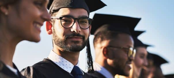 College, graduation and portrait of student man outdoor with friends for ceremony or event together. Diversity, education and success with happy graduate on academy campus for development or future.