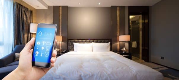 Smart phone with smart home and modern technology in a hotel room.
