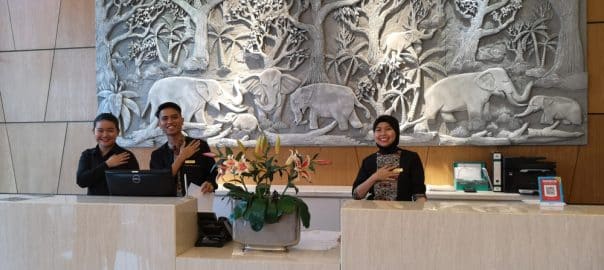 Hoteliers gesturing to incoming guests arriving at the Soluxe Hotel in Putatan.