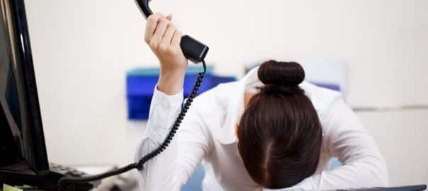 Young attractive business woman with phone in hand.