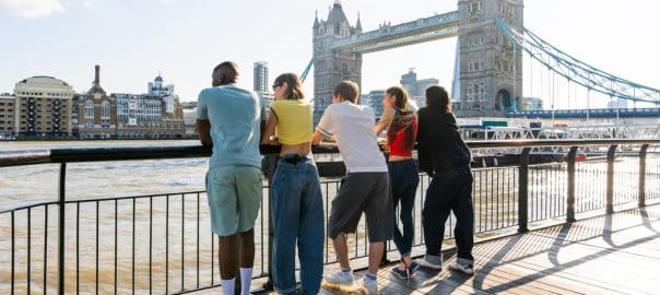 Multiracial group of happy young friends bonding in London city - Multiethnic teens students meeting and having fun in Tower Bridge area, UK - Concepts about youth lifestyle, travel and tourism.
