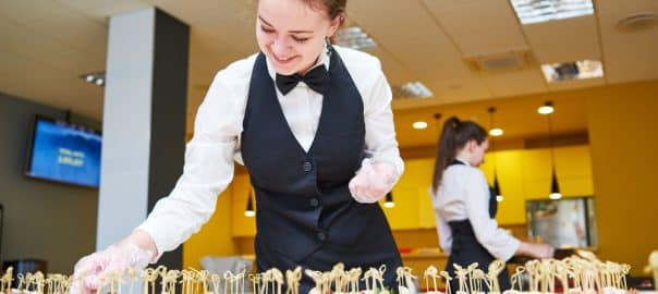 Restaurant waitress serving table with food