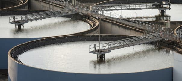 Modern urban wastewater treatment plant.Water purification is the process of removing undesirable chemicals, suspended solids and gases from contaminated water. Water cleaning facility outdoors.
