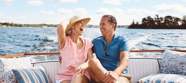 Laughing, happy couple and on a boat for retirement travel, summer freedom and holiday in Bali. Smile, love and a senior man and woman on a yacht for vacation adventure, luxury and a cruise date.