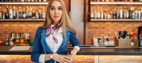 Stewardess at the bar counter in airport cafe