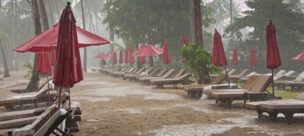 storm on the beach, heavy tropical rain in tourist hotel resort, bad weather.