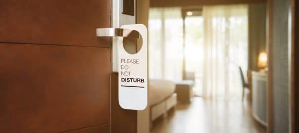 The hotel room with DO NOT DISTURB sign on the door.