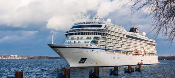 Kiel, Germany, April 12, 2019 - The cruise ship Viking Sky sails with tugboat assistance into the lock chamber of the lock of the Kiel-Canal in Holtenau.