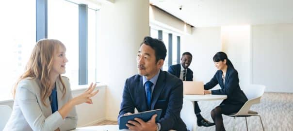 Group of multinational business people having a conversation in a lobby.